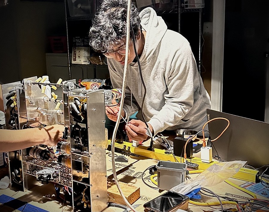 Vaibhav soldering and wiring a robot